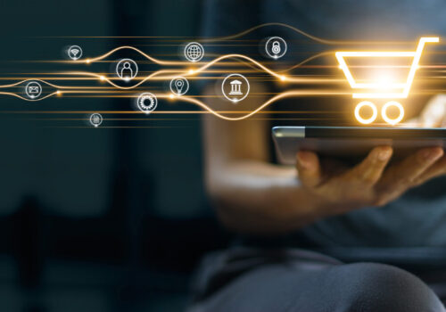 Online shopping and payment, Man using tablet with shopping cart icon, Digital marketing, Banking and finance on dark blue background.